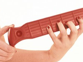 little fretty red guitar warm up device in hands